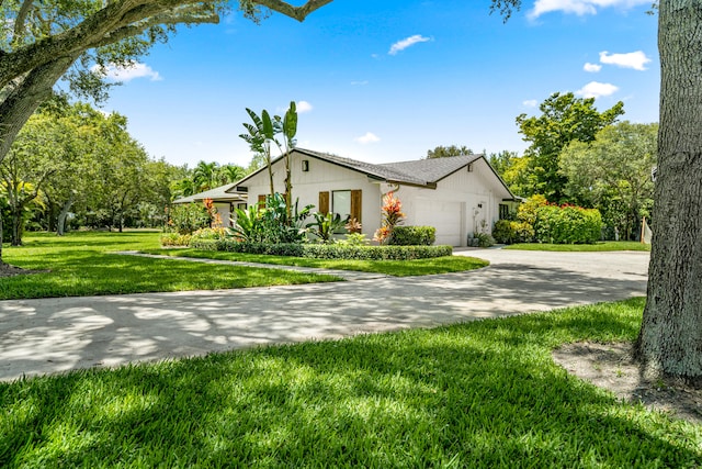 view of front of property with a front lawn and a garage