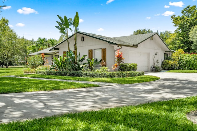 view of side of home featuring a lawn and a garage