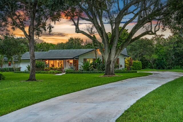 single story home with a lawn