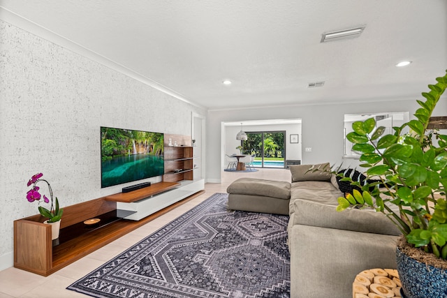 living room with crown molding and light tile patterned flooring