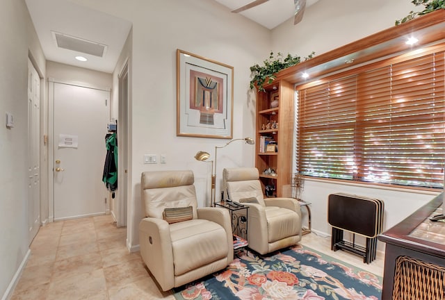 sitting room with light tile patterned floors and ceiling fan