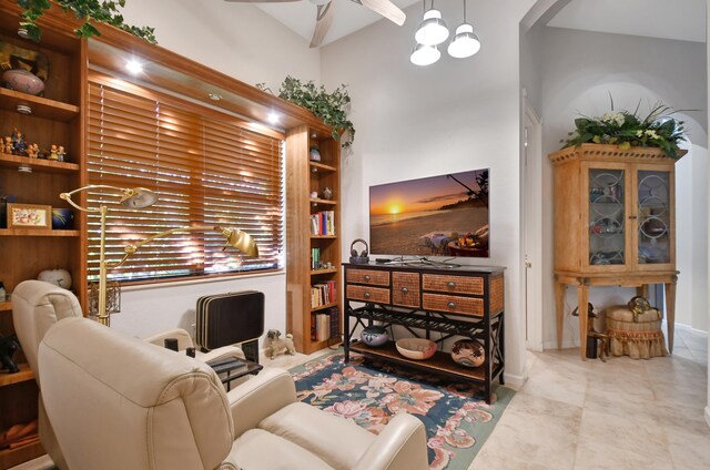 living room featuring ceiling fan and high vaulted ceiling