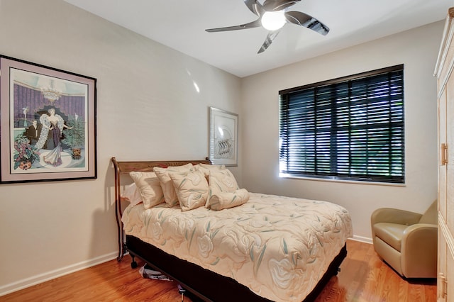 bedroom with ceiling fan and wood-type flooring