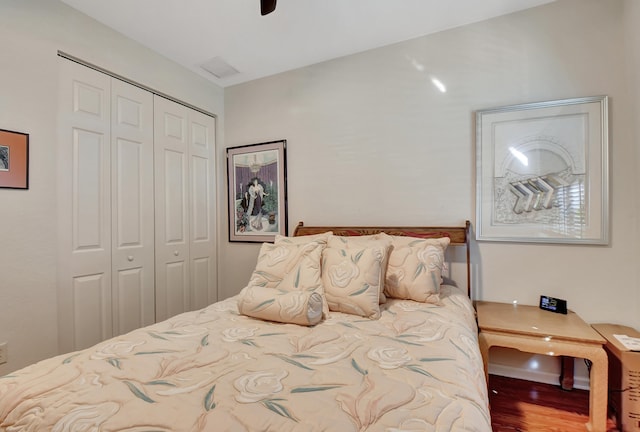 bedroom with hardwood / wood-style floors and a closet