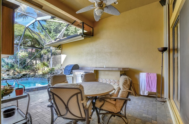 view of patio / terrace featuring ceiling fan and a lanai