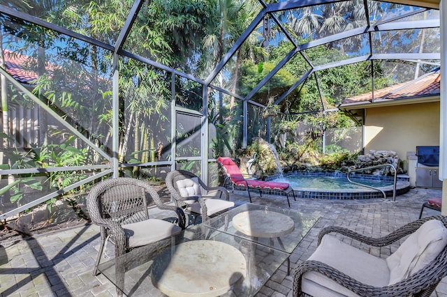 view of patio / terrace featuring pool water feature and glass enclosure