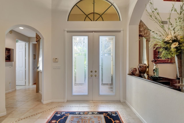 doorway to outside with french doors and light tile patterned floors