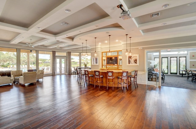 dining area featuring plenty of natural light, beamed ceiling, and dark wood-type flooring