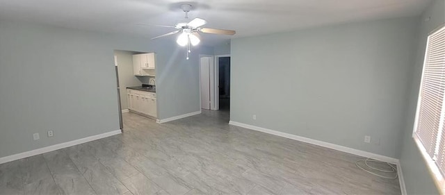 interior space with ceiling fan