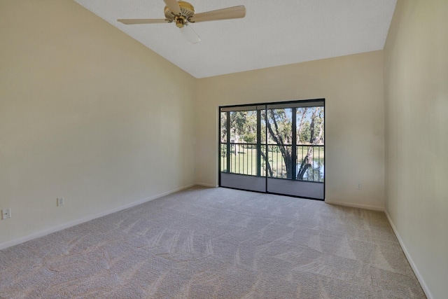 carpeted empty room featuring ceiling fan and high vaulted ceiling