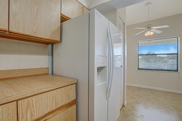 kitchen featuring ceiling fan, white refrigerator with ice dispenser, and light brown cabinets