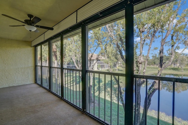 unfurnished sunroom with ceiling fan