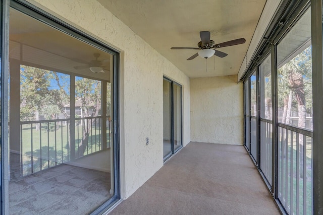 unfurnished sunroom with a wealth of natural light and ceiling fan