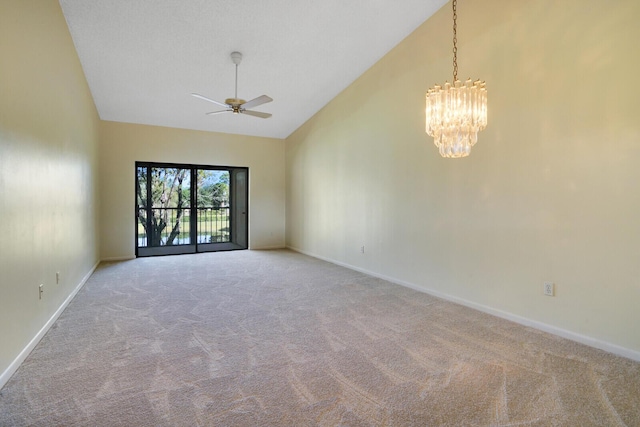 unfurnished room with ceiling fan with notable chandelier, high vaulted ceiling, and light carpet