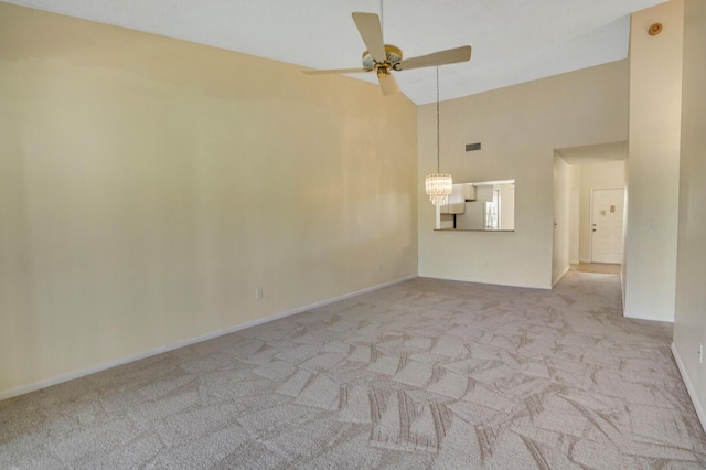 interior space featuring ceiling fan with notable chandelier and high vaulted ceiling