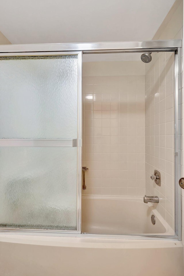 bathroom with shower / bath combination with glass door