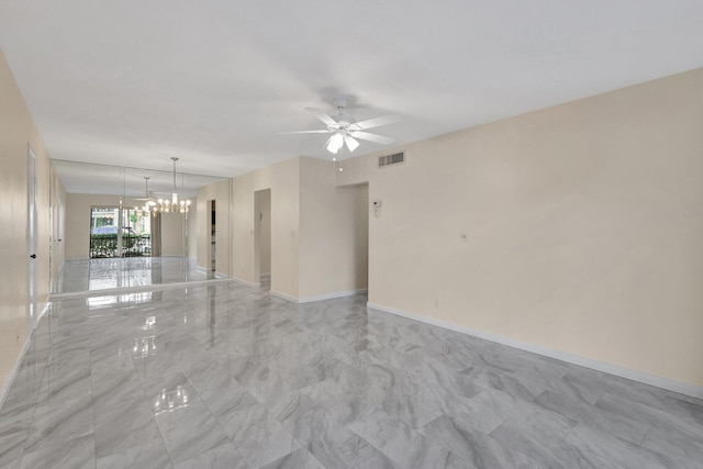 unfurnished room with ceiling fan with notable chandelier