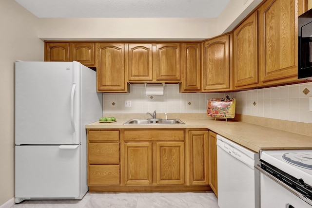 kitchen with tasteful backsplash, sink, and white appliances