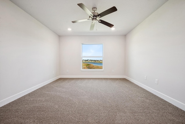 carpeted empty room featuring ceiling fan