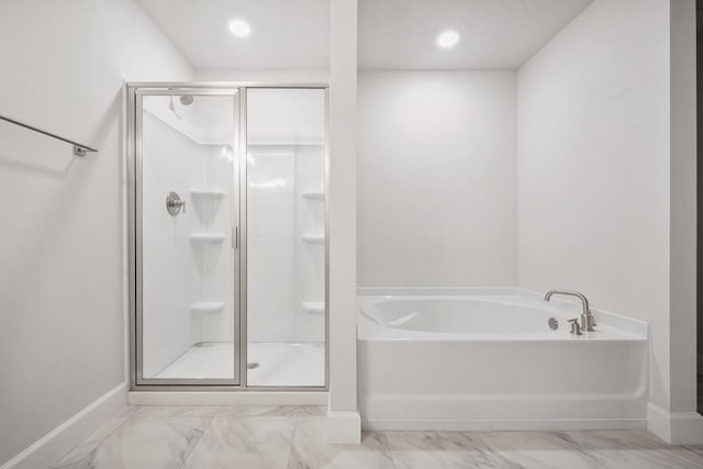 bathroom with separate shower and tub