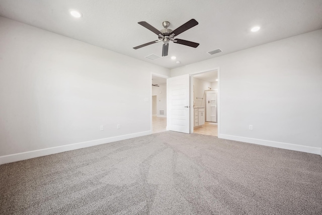 unfurnished bedroom featuring ceiling fan, ensuite bathroom, and light carpet