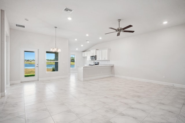 unfurnished living room with ceiling fan with notable chandelier and lofted ceiling