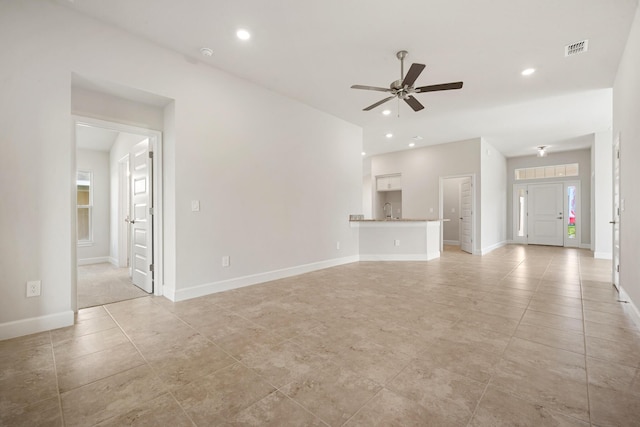 unfurnished living room with ceiling fan