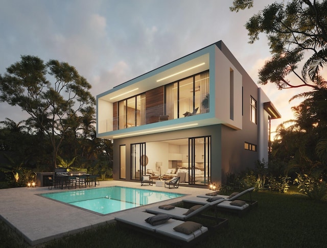 back house at dusk featuring a patio