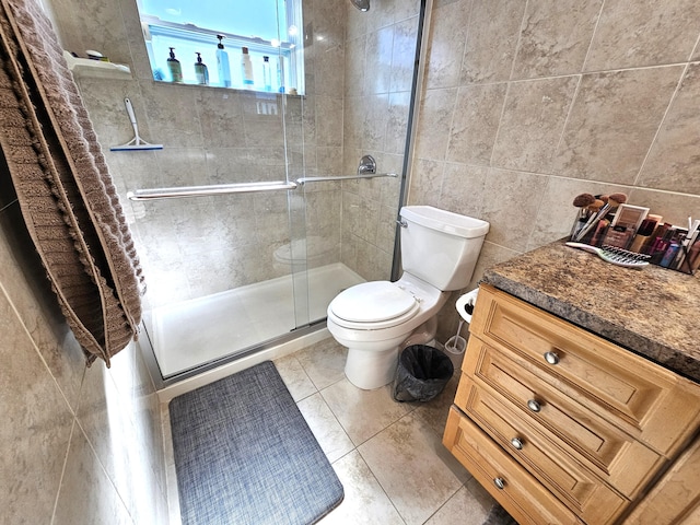 bathroom featuring toilet, tile patterned flooring, tile walls, and walk in shower