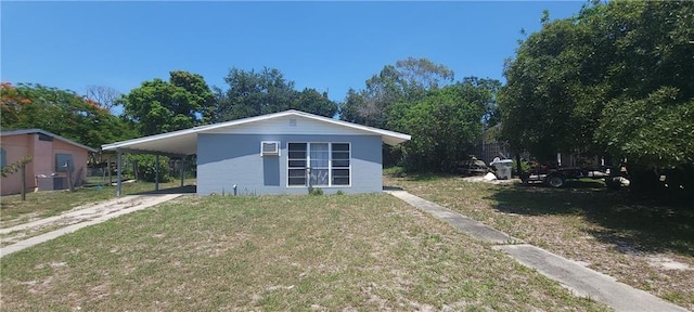 exterior space featuring a carport and a front yard