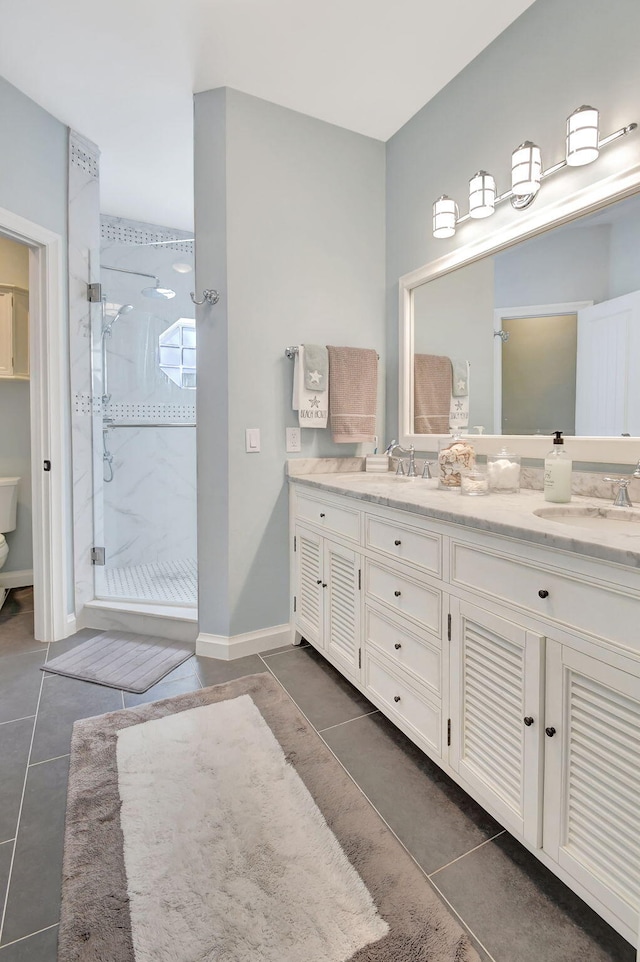 bathroom with tile patterned floors, vanity, and a shower with shower door