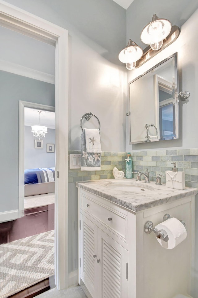 bathroom with tile patterned floors, vanity, and an inviting chandelier