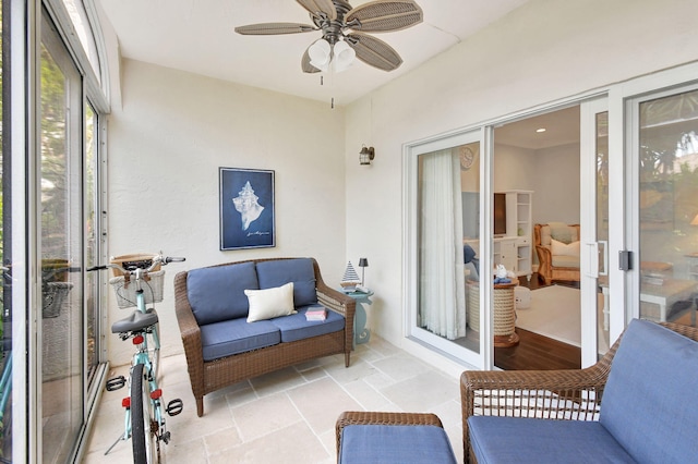 sunroom featuring ceiling fan