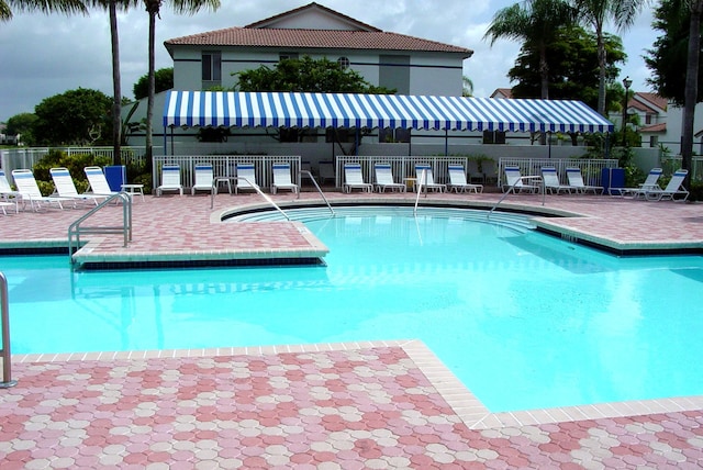 view of swimming pool featuring a patio area