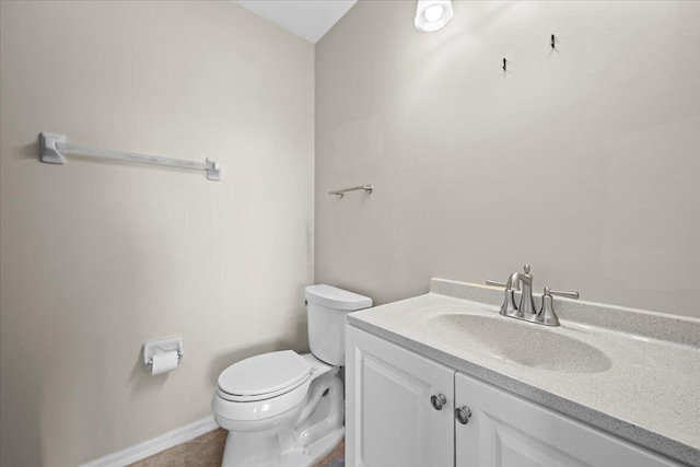 bathroom featuring tile patterned flooring, vanity, and toilet