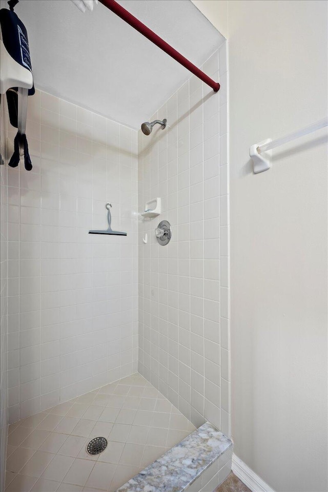 bathroom with tiled shower