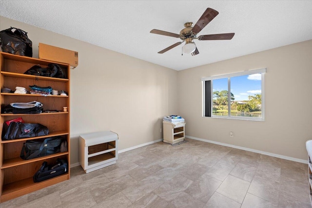 bedroom with a textured ceiling and ceiling fan