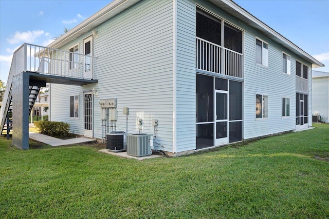 view of property exterior featuring a yard and central AC