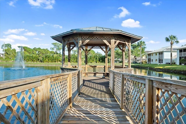 view of dock featuring a gazebo and a water view