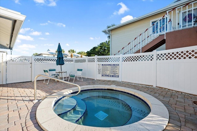 view of pool featuring a patio and a hot tub