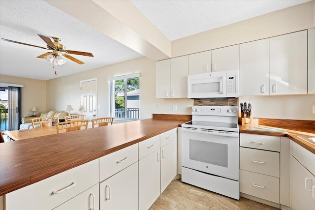 kitchen with white cabinetry, white appliances, a textured ceiling, and wooden counters