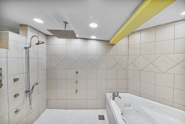 bathroom with tile walls and independent shower and bath