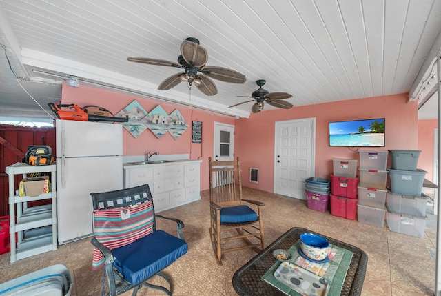 interior space with ceiling fan and sink