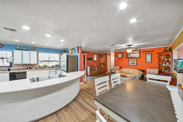 dining space with a textured ceiling, light hardwood / wood-style flooring, and ceiling fan