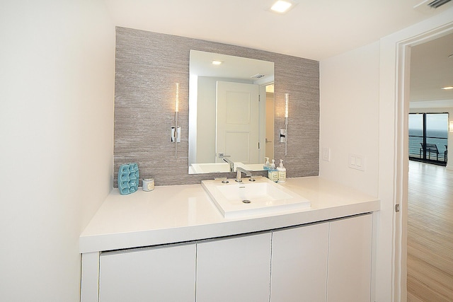 bathroom with hardwood / wood-style floors and vanity