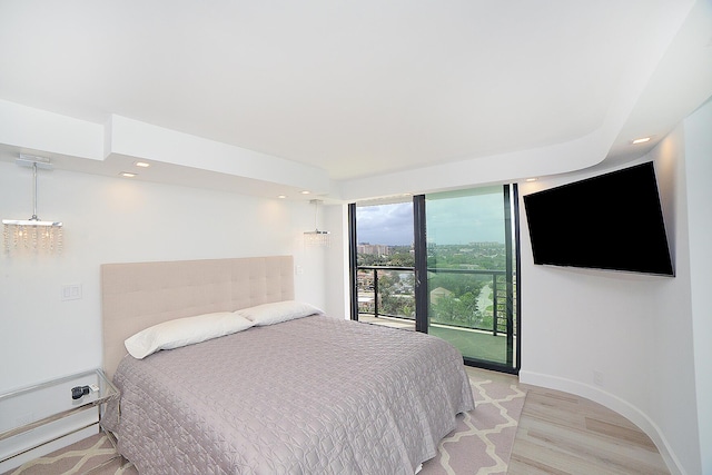 bedroom with access to exterior and light wood-type flooring