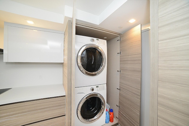 laundry area featuring stacked washer and dryer