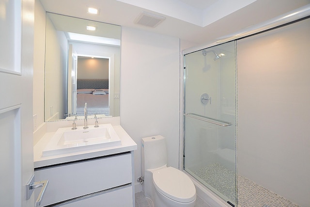 bathroom with vanity, toilet, and walk in shower