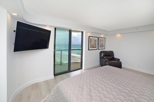 bedroom with access to outside and light hardwood / wood-style flooring