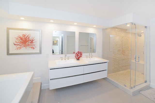 bathroom featuring tile patterned flooring, vanity, and walk in shower